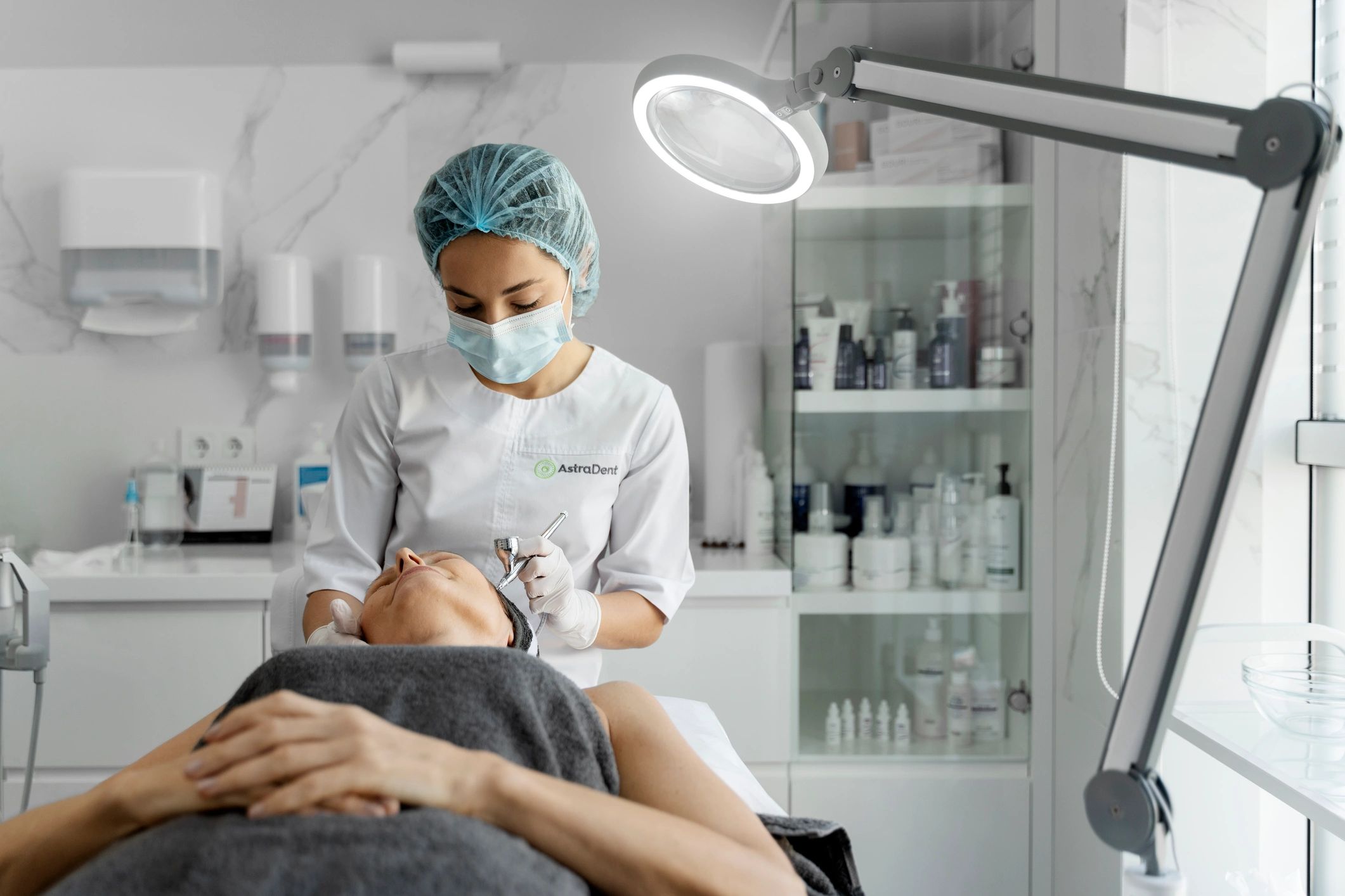 Certified aesthetician performing facial treatment